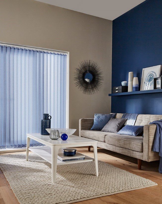 LIGHTER BLUE COLOUR VERTICAL BLINDS WITH SOFA UPHOLSTERY BY DUBAI BLINDS